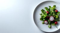 Fresh green salad with sliced radishes and strawberries served on minimal white ceramic plate against light background, styled for restaurant menu.