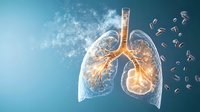 Glowing anatomical lungs with bronchial tree illuminated from within against blue background with floating particles and smoke effects. Medical science concept.