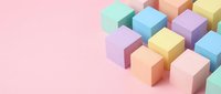 Colorful pastel cubes arranged in geometric pattern on pink background creating modern minimalist composition for creative design projects and presentations.
