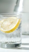 Refreshing glass of sparkling water with fresh lemon slice and ice cubes, perfect for beverage, wellness, hydration, and food and drink marketing campaigns.