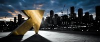 Golden arrow pointing upward against urban skyline at dusk, symbolizing growth, success, and financial progress for business and investment concepts.