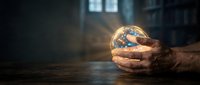 Hands holding glowing globe on wooden surface with blurred urban background, representing global business, environmental care, and sustainable development concepts.
