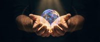 Hands holding glowing earth globe with blue light energy, representing global connection, sustainability, and environmental care for business and technology concepts.