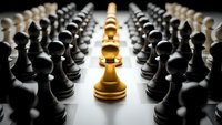 Golden chess pawn stands out among black pawns, symbolizing leadership, uniqueness, and strategic thinking in business and competition concepts.