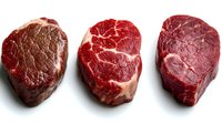 Three premium raw beef steaks displaying different cuts and marbling patterns on white background, perfect for culinary and food industry marketing.