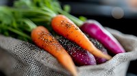 Fresh organic carrots and purple radishes with water drops on rustic burlap, macro food photography with selective focus and natural lighting.