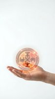 Hand holding glowing puzzle piece sphere with warm light effects on white background for business solution and innovation concepts.