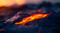 Glowing hot lava flow with vibrant orange magma streaming through dark volcanic rock during sunset, creating dramatic natural light effects and textures.