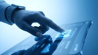 Hand in dark glove touching glowing digital interface on tablet screen against blue background, representing technology, innovation, and futuristic digital interaction for business solutions.