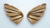 Golden angel wings crafted from layered feathers on white background, isolated decorative element for creative design projects and artistic compositions.