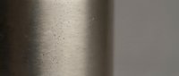 Dust particles floating in sunlight beam through window creating atmospheric lighting effect in minimalist interior space for meditation and wellness concepts.