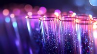 Sparkling champagne glasses with purple and blue bokeh lights creating festive party atmosphere for celebrations and special events.