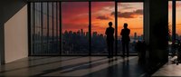 Two silhouetted figures stand in modern loft overlooking city skyline at dramatic sunset, ideal for corporate, lifestyle, and architectural design projects.