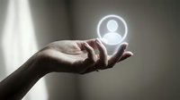 Hand holding glowing user profile icon symbol, representing digital identity, account management, customer service, and online networking technology concepts.
