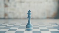 Blue chess king piece standing alone on chessboard with soft focus background, representing leadership, strategy and power in business concept.