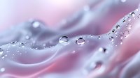 Macro photography of water drops on delicate pink and blue surface creating abstract pattern with light refraction and bokeh effect for artistic backgrounds.