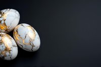 White marble eggs with gold leaf veining on dark background, elegant minimal composition with copy space for luxury product presentation.