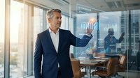 Mature male professional with gray hair and medium complexion wearing dark business suit interacting with digital financial analytics display in modern office environment with city skyline view.
