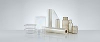 Various cosmetic containers and packaging materials including glass jars, metal tubes, and bottles arranged on white surface for beauty product mockups.