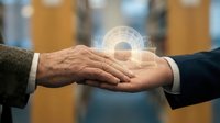 Diverse business professionals joining hands with glowing digital interface overlay, symbolizing teamwork, partnership, and technology integration in corporate collaboration and agreement.