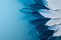 Delicate feather arrangement in gradient shades of blue and white creating abstract pattern on turquoise background, suitable for modern interior design and wall art.