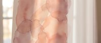 Soft watercolor stains in rose and beige tones on translucent fabric, creating an artistic, dreamy effect suitable for backgrounds, textile design, and creative projects.