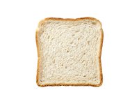 Slice of white bread with golden crust isolated on white background, ready for design use in food, bakery, and culinary projects.