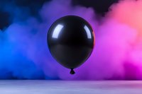 Black balloon floating against vibrant blue, purple and pink smoke background, creating dramatic contrast and mysterious atmosphere for party and celebration designs.