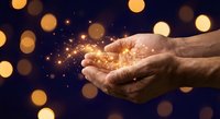 Cupped hands holding magical golden light particles with sparkling bokeh effects against dark blue background for spiritual and inspirational concepts.