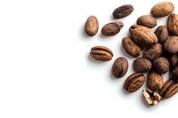 Fresh whole and cracked pecan nuts scattered on white background with copy space, isolated organic nuts for healthy snacking and baking.