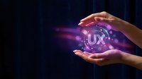 Hands protecting glowing UX user experience sphere with digital interface elements and purple light effects on dark technology background.