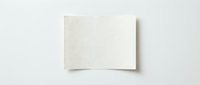 Blank cream colored paper sheet with curved edges on white background, suitable for mockups, branding, and design presentations.