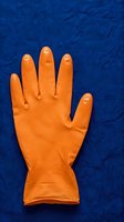 Orange rubber glove displayed flat on deep blue textured background, showing palm and fingers. Suitable for cleaning, household chores, safety, and hygiene concepts.