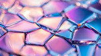 Macro view of iridescent geometric pattern with pink and blue gradient colors showing crystalline structure with light reflections and transparent surfaces.
