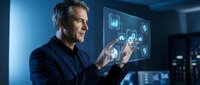 Middle-aged Caucasian businessman in dark suit interacting with futuristic holographic interface displaying data analytics and charts in modern office environment.