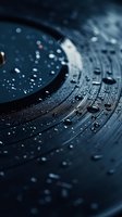 Macro shot of vinyl record with water droplets on surface, creating atmospheric mood for music-related designs and nostalgic concepts.