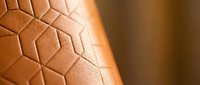 Reptile skin texture with geometric scale pattern in warm brown tones, suitable for backgrounds, nature designs, and wildlife-themed projects.
