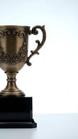 Ornate bronze trophy cup with decorative rose engravings and elegant handle on black base, symbolizing achievement and victory in competitions and awards ceremonies.