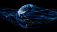 Global network connections visualized with glowing blue light trails surrounding Earth at night showing Americas continent with city lights against dark space background.