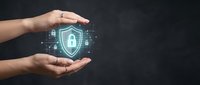 Hands protecting digital security shield with lock icon and network connections on dark background for cybersecurity and data protection concepts.
