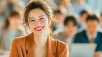 Happy young Asian businesswoman smiling confidently in modern office environment with colleagues working in background for corporate presentations.