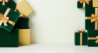 Luxury gift boxes in emerald green and gold with ribbon bows arranged on white surface, ideal for holiday, birthday, and celebration marketing materials.