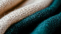Natural and teal burlap fabric texture in macro view showing detailed woven pattern and fibers, creating abstract diagonal lines and contrast in colors.