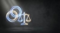 Neon glowing scales of justice symbol with blue and gold light effects on dark background, representing law, legal services, and attorney concepts.