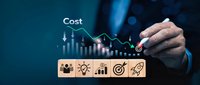 Businessman pointing at cost reduction graph with wooden blocks showing business strategy icons for finance and growth planning.