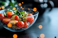 Fresh cherry tomatoes and herbs in glass bowl with water droplets and bokeh light effects, dark moody background for food photography and menu design.