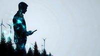 Silhouette of man filled with starry galaxy texture against wind turbine farm background, pine forest landscape at dusk creating environmental technology concept.