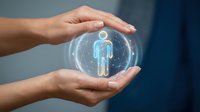 Hands holding glowing holographic human figure icon in transparent sphere, representing digital healthcare, medical technology, and personalized wellness solutions.