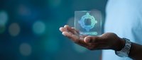 Professional hand presenting holographic security shield interface with digital protection technology for cybersecurity and data safety solutions.