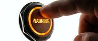 Male hand with medium skin tone pressing illuminated warning button with glowing orange text on white background for alert, danger, caution, and emergency concepts.